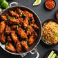 spicy chicken wings and noodles on the side